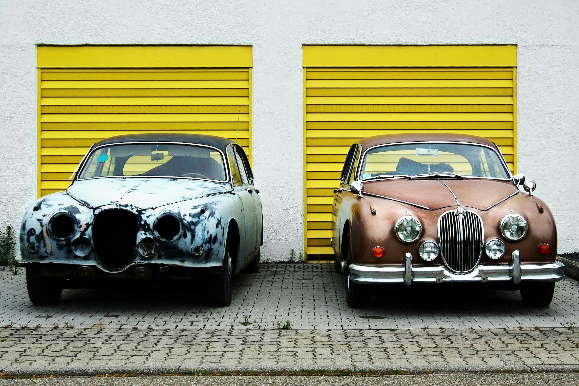 Image of two cars parked side by side. One is new and the other is old.